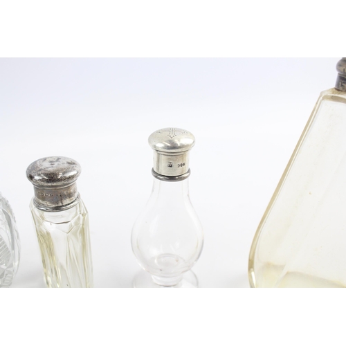 2297 - Eight .925 silver topped glass vanity bottles