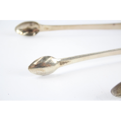 2304 - Two pairs of antique hallmarked sterling silver sugar tongs - approx. gross weight 75g