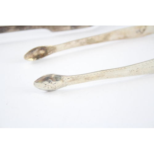 2318 - Two pairs of Georgian hallmarked sterling silver sugar tongs - approx. gross weight 93g