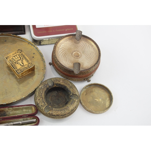 323 - A collection of tobacciana to include tobacco tins, ashtrays etc.