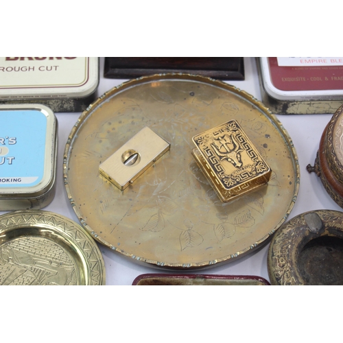 323 - A collection of tobacciana to include tobacco tins, ashtrays etc.