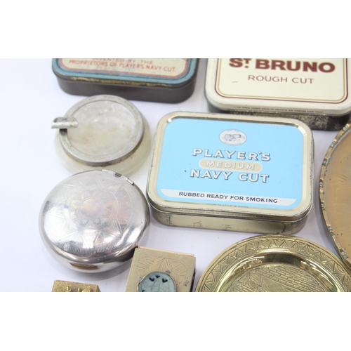 323 - A collection of tobacciana to include tobacco tins, ashtrays etc.