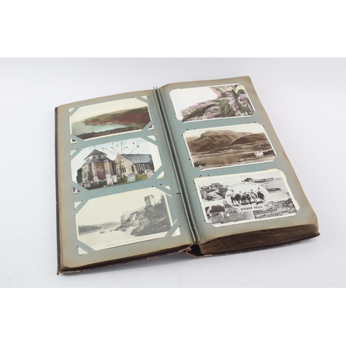 519 - A vintage postcard album containing a large collection of postcards