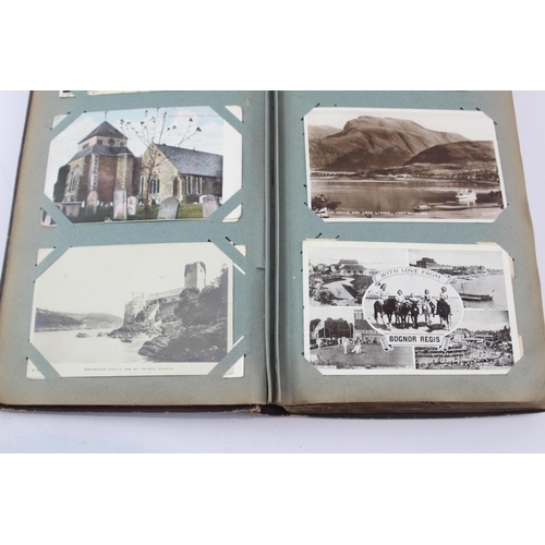 519 - A vintage postcard album containing a large collection of postcards