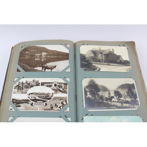 519 - A vintage postcard album containing a large collection of postcards