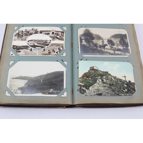 519 - A vintage postcard album containing a large collection of postcards