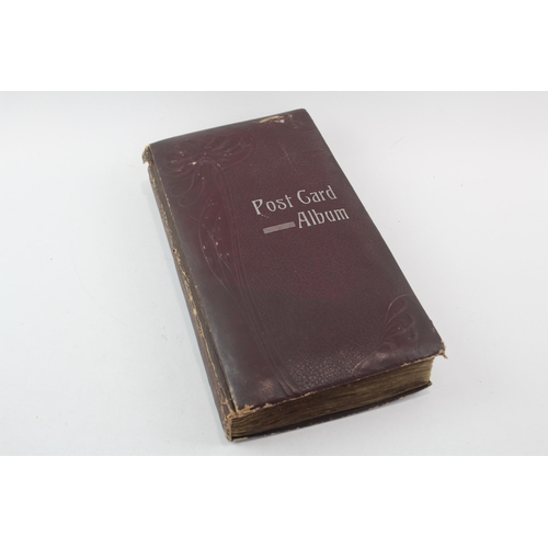 519 - A vintage postcard album containing a large collection of postcards