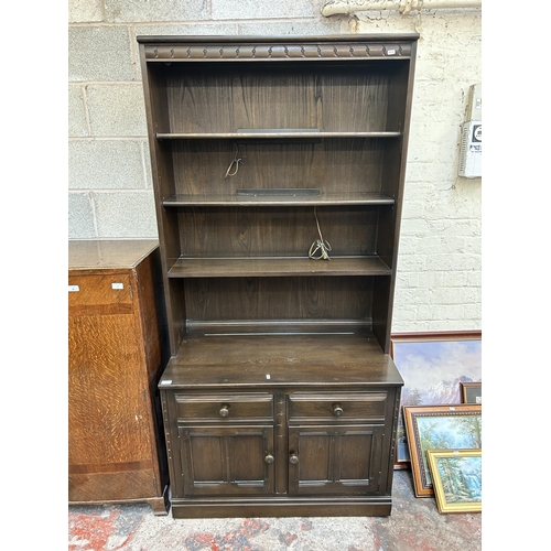 1 - An Ercol dark elm bookcase - approx. 197cm high x 98cm wide x 50cm deep