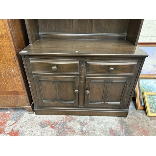 1 - An Ercol dark elm bookcase - approx. 197cm high x 98cm wide x 50cm deep