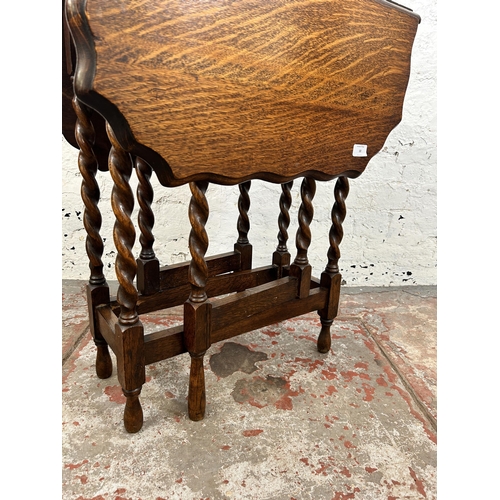 10 - An early 20th century oak pie crust edge drop leaf gate leg occasional table on barley twist support... 