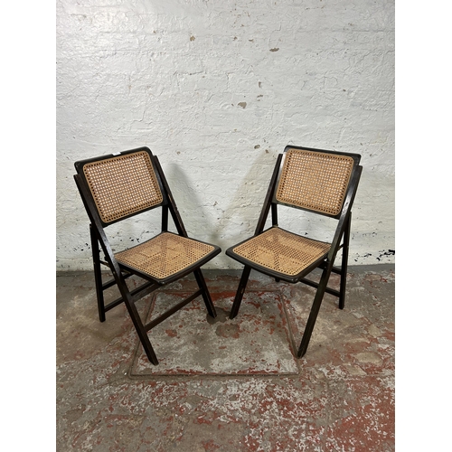 101 - A pair of mid 20th century wood and rattan folding chairs