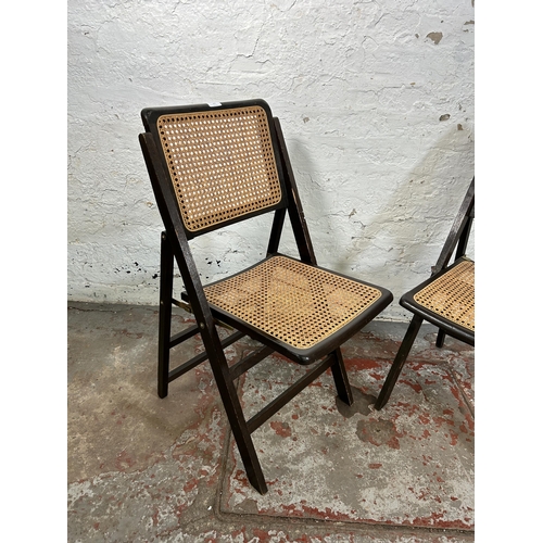 101 - A pair of mid 20th century wood and rattan folding chairs