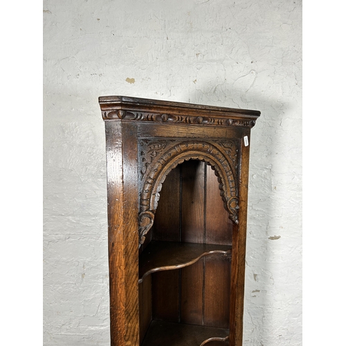 102A - A Titchmarsh & Goodwin carved oak narrow corner cabinet - approx. 167cm high x 43cm wide x 23cm deep