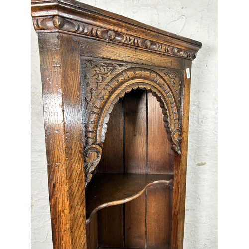 102A - A Titchmarsh & Goodwin carved oak narrow corner cabinet - approx. 167cm high x 43cm wide x 23cm deep