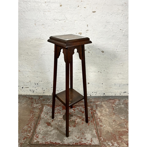 104 - An Arts & Crafts oak two tier jardinière stand - approx. 105cm high x 28cm wide x 28cm deep