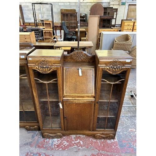 105 - An Art Deco style carved oak side by side bureau bookcase - approx. 123cm high x 106cm wide x 29cm d... 