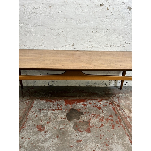 108 - A mid 20th century teak coffee table - approx. 40cm high x 50cm wide x 131cm long