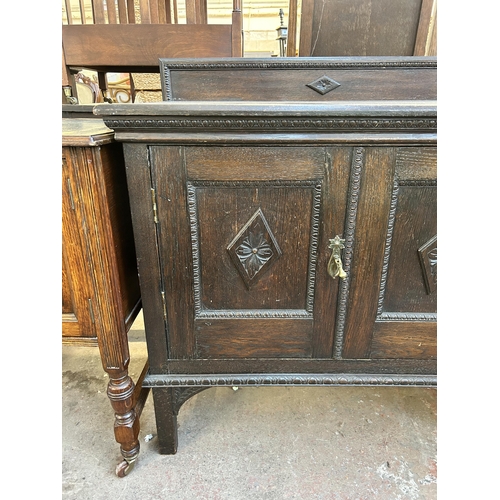 115 - An early 20th century carved oak two door cabinet with fitted interior - approx. 93cm high x 91cm wi... 