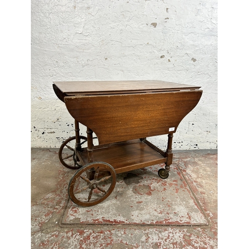 116 - A mid 20th century mahogany drop leaf two tier tea trolley - approx. 62cm high x 48cm wide x 76cm lo... 