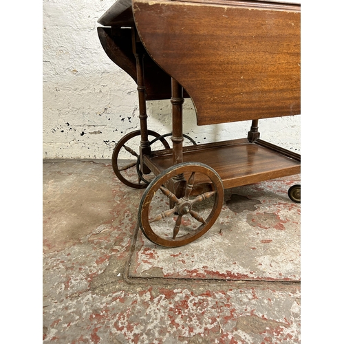 116 - A mid 20th century mahogany drop leaf two tier tea trolley - approx. 62cm high x 48cm wide x 76cm lo... 