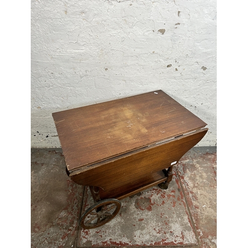 116 - A mid 20th century mahogany drop leaf two tier tea trolley - approx. 62cm high x 48cm wide x 76cm lo... 