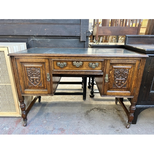 117 - A late 19th century carved oak and green leather writing desk - approx. 77cm high x 118cm wide x 54c... 