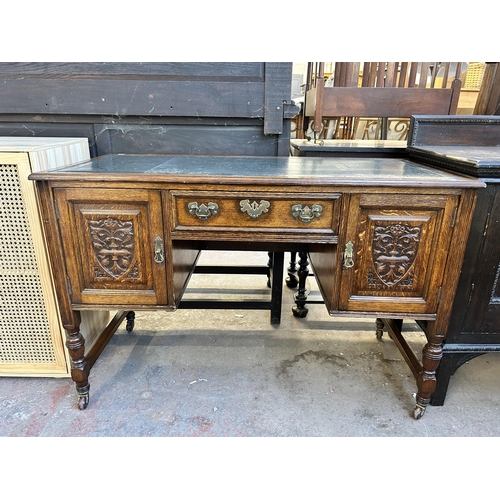 117 - A late 19th century carved oak and green leather writing desk - approx. 77cm high x 118cm wide x 54c... 