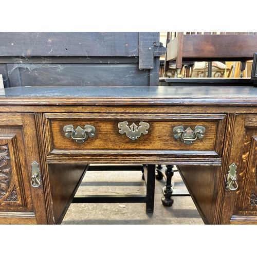 117 - A late 19th century carved oak and green leather writing desk - approx. 77cm high x 118cm wide x 54c... 