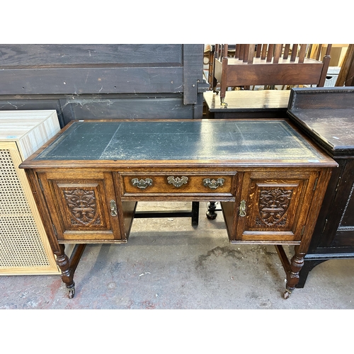 117 - A late 19th century carved oak and green leather writing desk - approx. 77cm high x 118cm wide x 54c... 