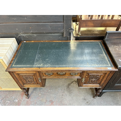 117 - A late 19th century carved oak and green leather writing desk - approx. 77cm high x 118cm wide x 54c... 