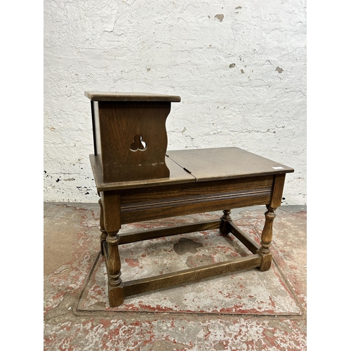 118 - A carved oak telephone table - approx. 66cm high x 38cm wide 66cm long