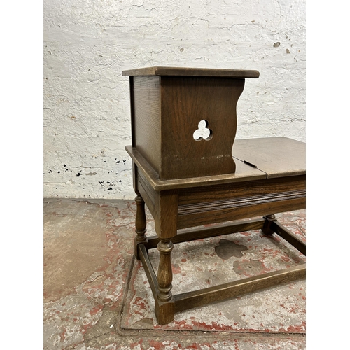 118 - A carved oak telephone table - approx. 66cm high x 38cm wide 66cm long