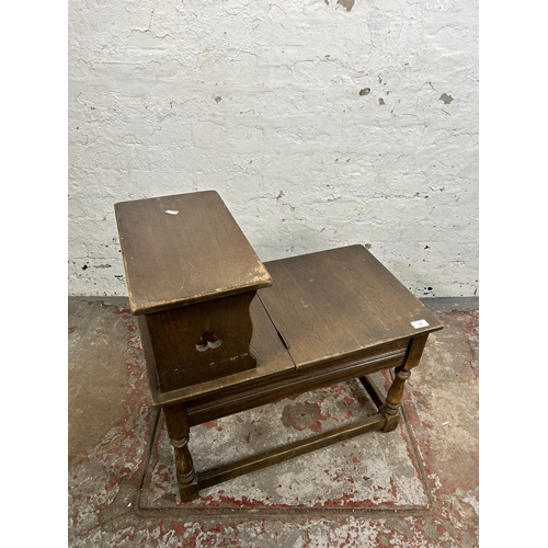 118 - A carved oak telephone table - approx. 66cm high x 38cm wide 66cm long