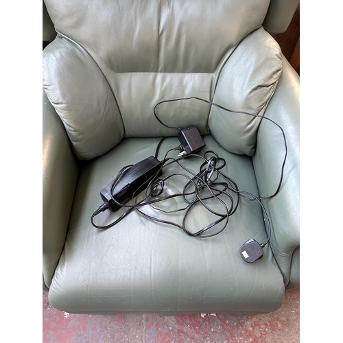 133 - A green leather electric reclining arm chair with remote control and power adapter