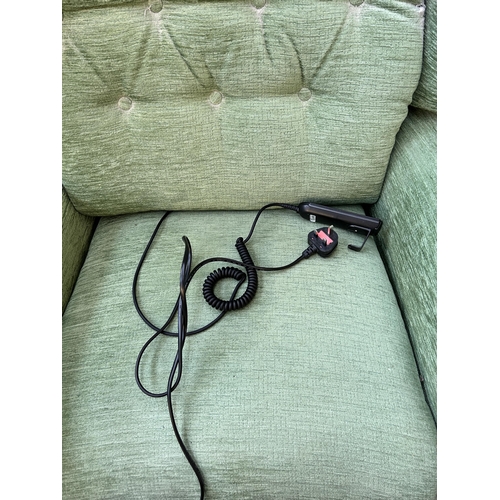 134 - A green fabric upholstered electric reclining arm chair with remote control and power lead