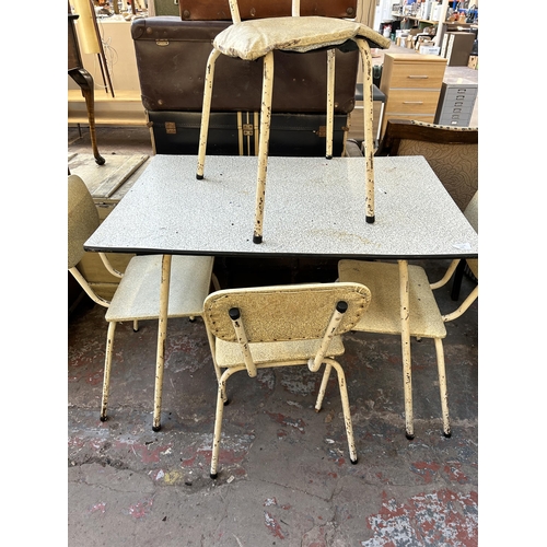 135 - A mid 20th century white tubular metal and melamine rectangular dining table and four chairs