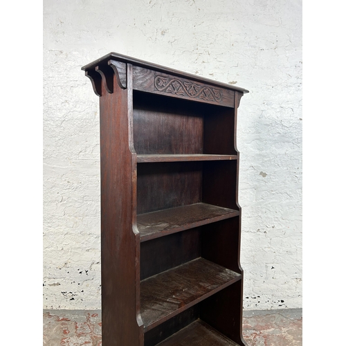 17 - An early 20th century carved oak four tier waterfall bookcase - approx. 116cm high x 61cm wide x 25c... 