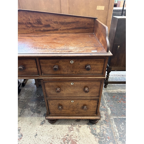 19 - A Victorian mahogany writing desk with galleried back and seven drawers - approx. 110cm high x 165cm... 