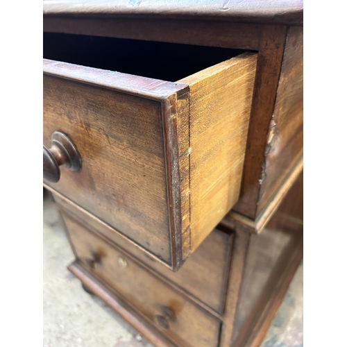 19 - A Victorian mahogany writing desk with galleried back and seven drawers - approx. 110cm high x 165cm... 