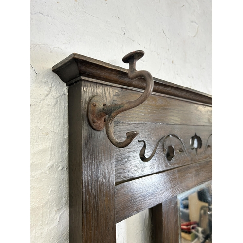 21 - An Arts & Crafts oak hall stand - approx. 185cm high x 8cm wide x 28cm deep