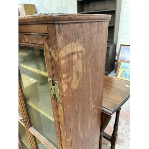 23 - A Georgian oak glazed two door bookcase with two lower drawers - approx. 120cm high x 63cm wide x 27... 