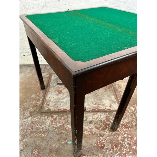 25 - A Georgian mahogany fold over games table - approx. 74cm high x 84cm wide x 42cm deep when closed