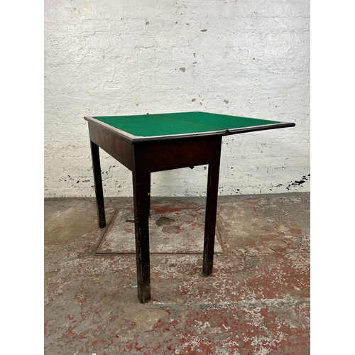 25 - A Georgian mahogany fold over games table - approx. 74cm high x 84cm wide x 42cm deep when closed