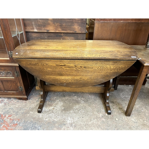 27 - An oak drop leaf oval dining table