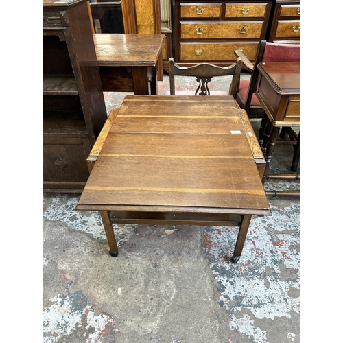 32 - A mid 20th century oak two tier tea trolley - approx. 65cm high x 64cm wide x 80cm long