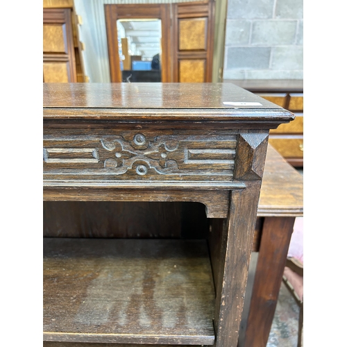 33 - A carved oak two tier bookcase - approx. 107cm high x 91 cm wide x 30cm deep