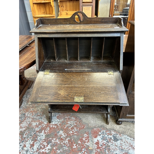 34 - An early 20th century oak bureau - approx. 110cm high x 76cm wide x 31cm deep