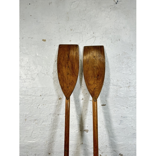 35 - A pair of mid 20th century pine and plywood boat oars - approx. 180cm long