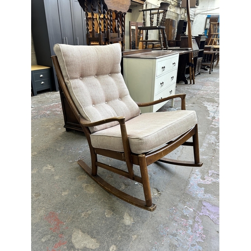 37 - A mid 20th century Parker Knoll PK1016-19 beech and fabric upholstered rocking chair