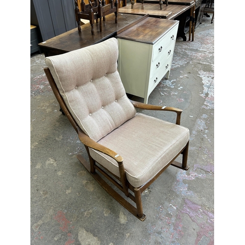 37 - A mid 20th century Parker Knoll PK1016-19 beech and fabric upholstered rocking chair